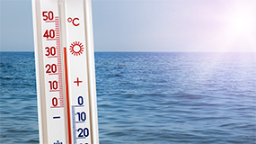 thermometer in front of ocean water