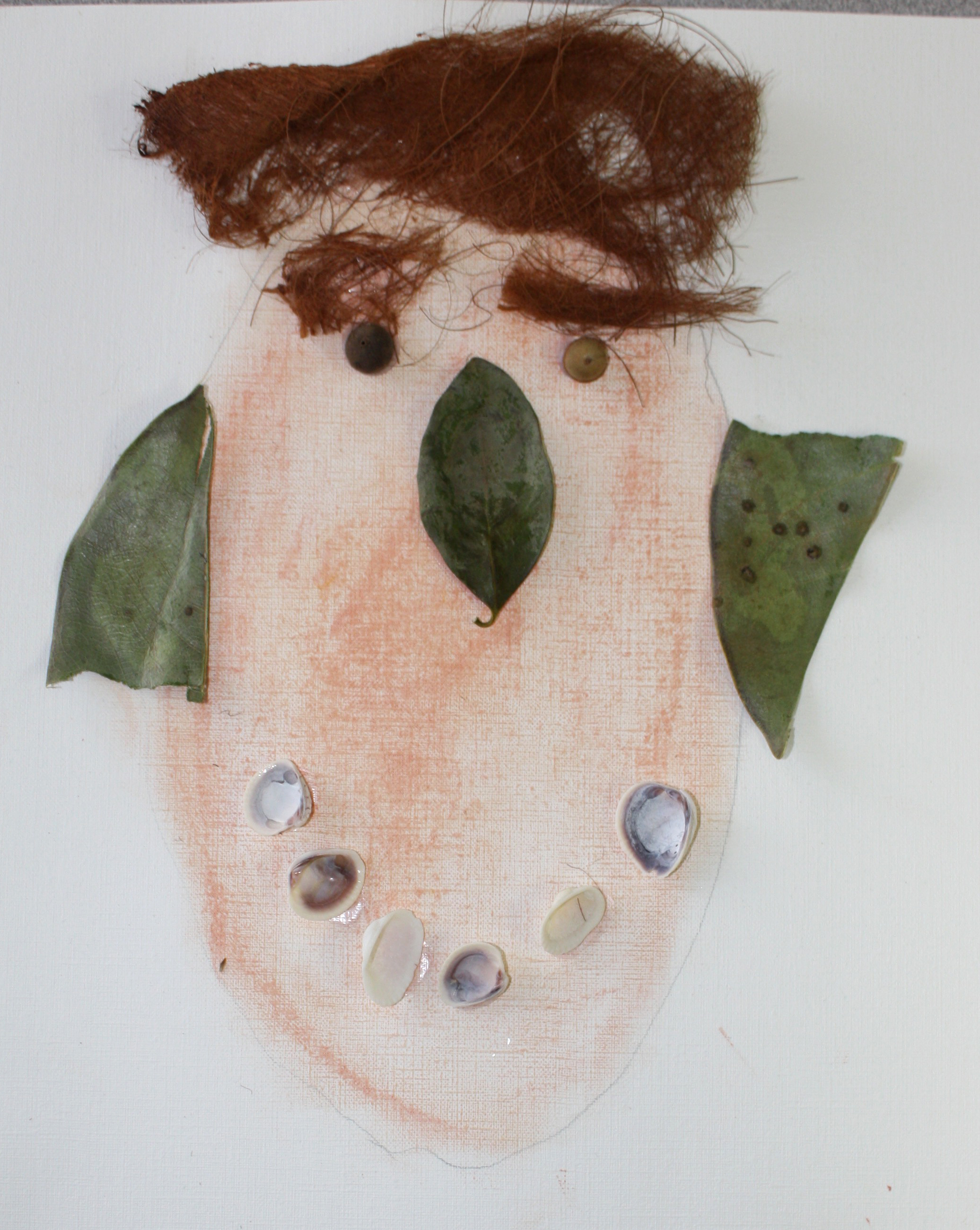 Child's self-portrait collage using natural materials