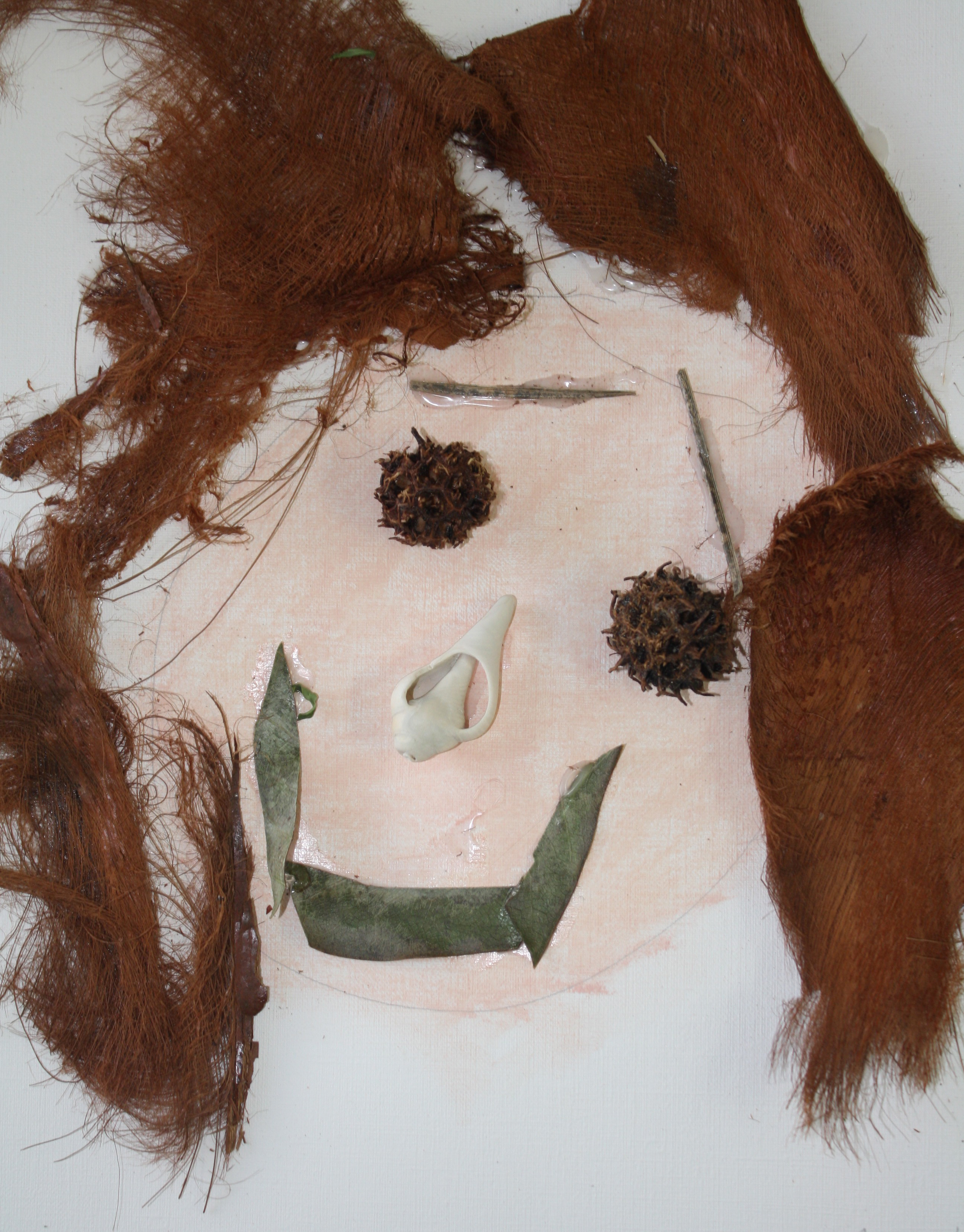Child's self-portrait collage using natural materials